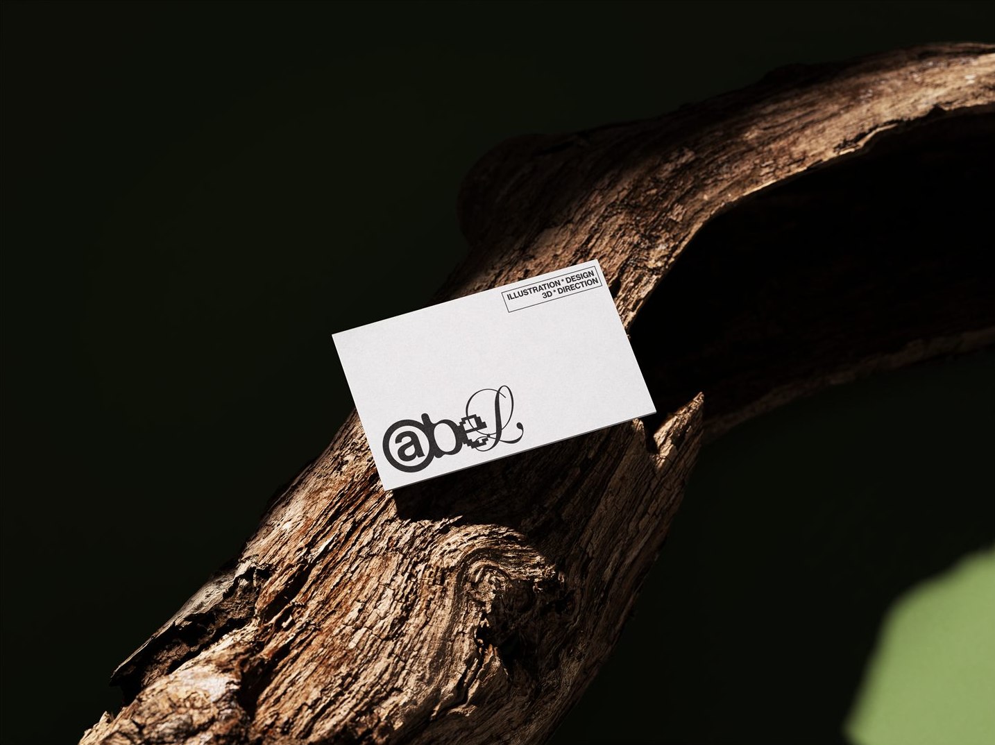 Abel business card leaning against driftwood