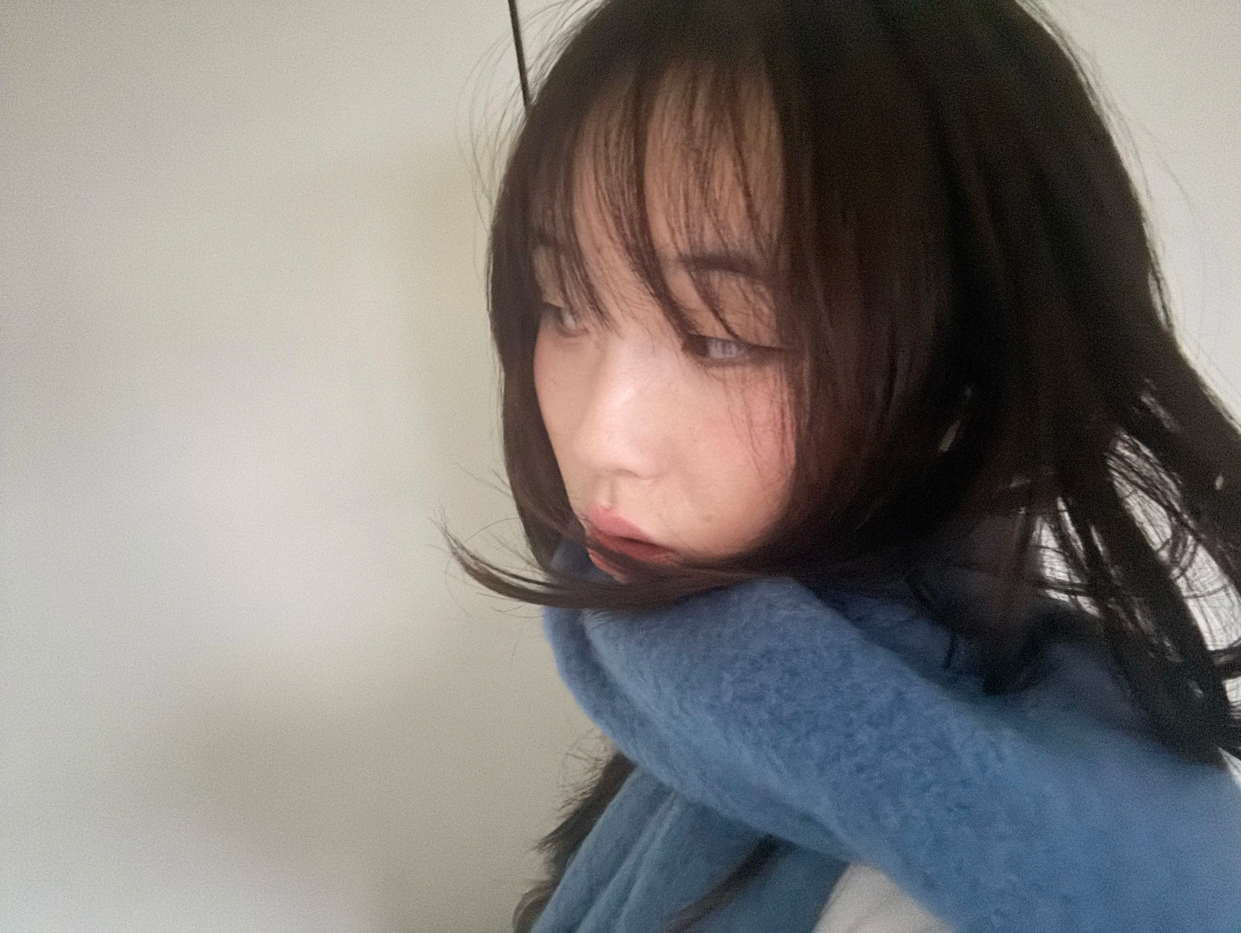 A windblown selfie in a blue sweater