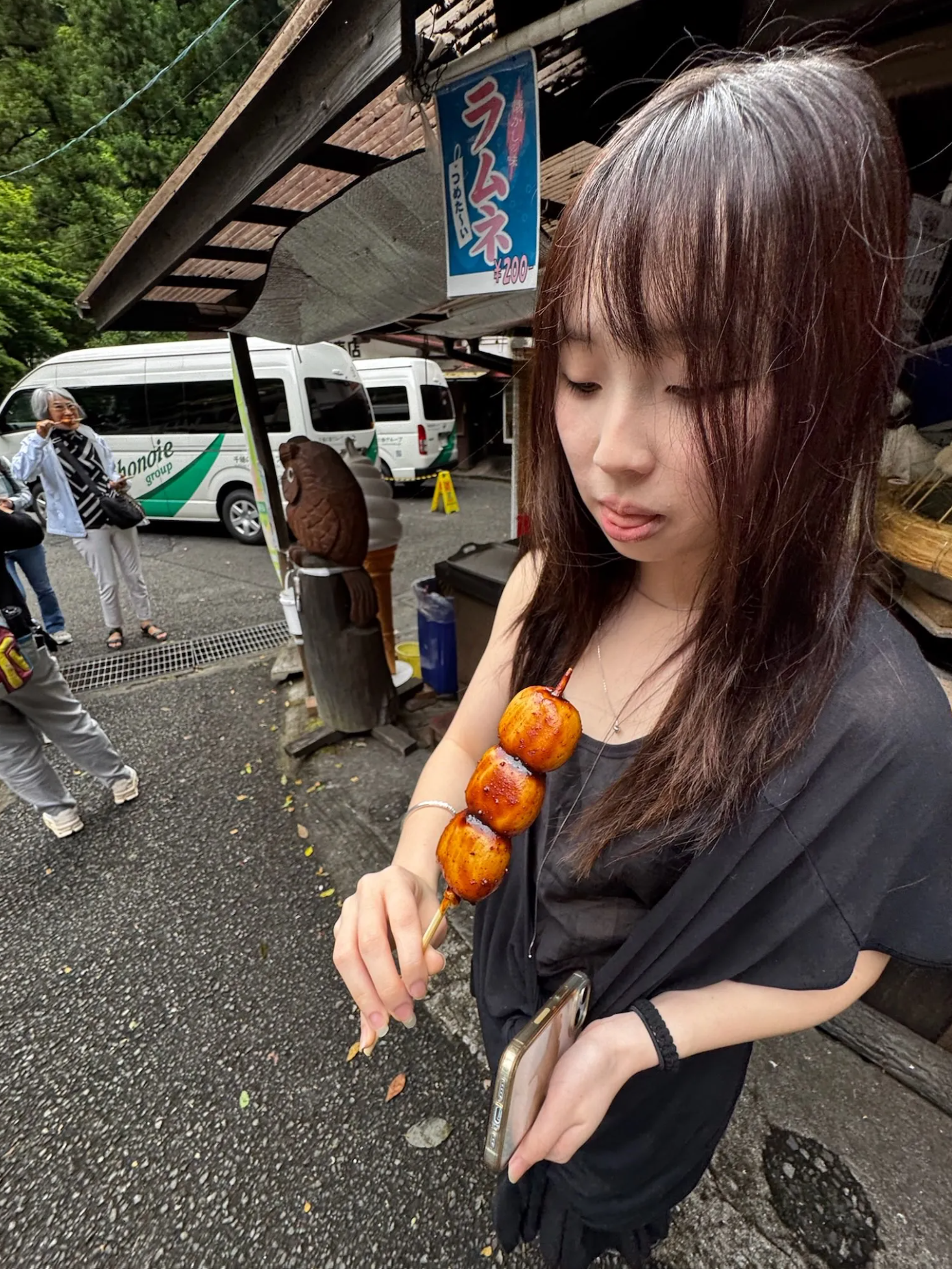 Holding a skewer of dango while traveling